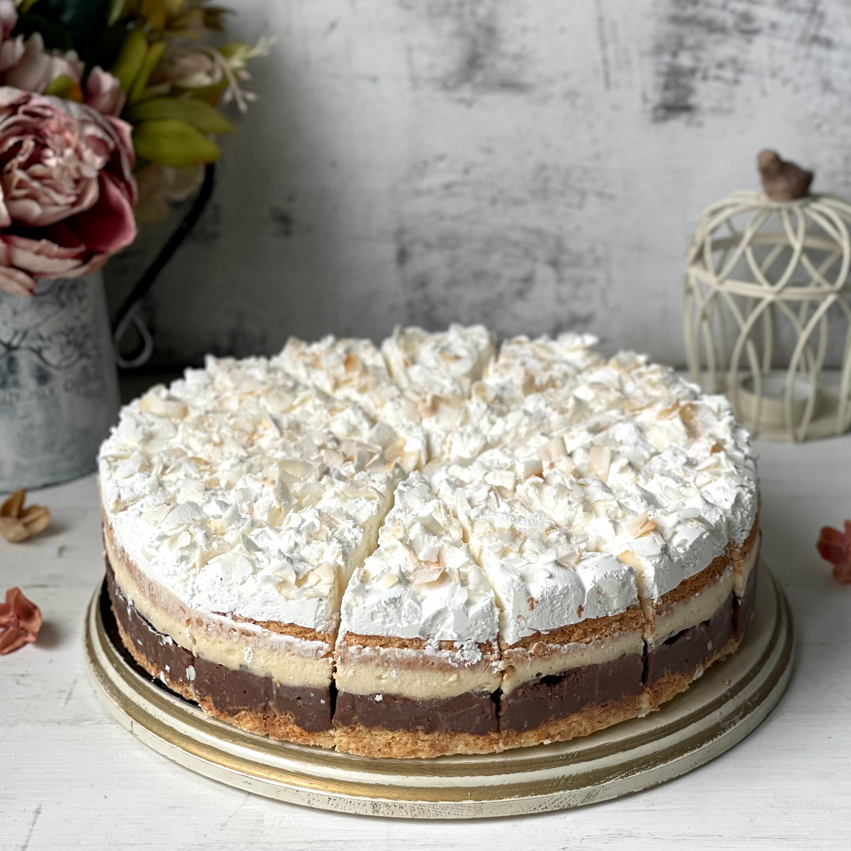 Изысканный торт из слоев кокосового бисквита, крема на основе сыра Маскарпоне и насыщенного шоколадного слоя. Сверху торт украшен обжаренным кокосовым кранчем. изображение 2